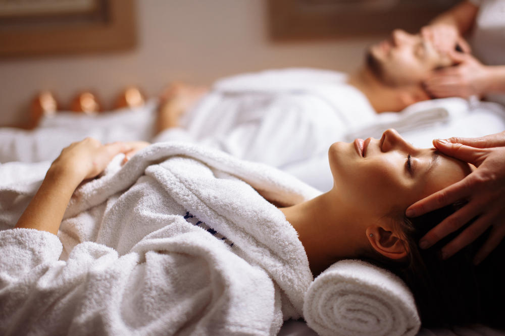 Guests relaxing during a massage in white robes